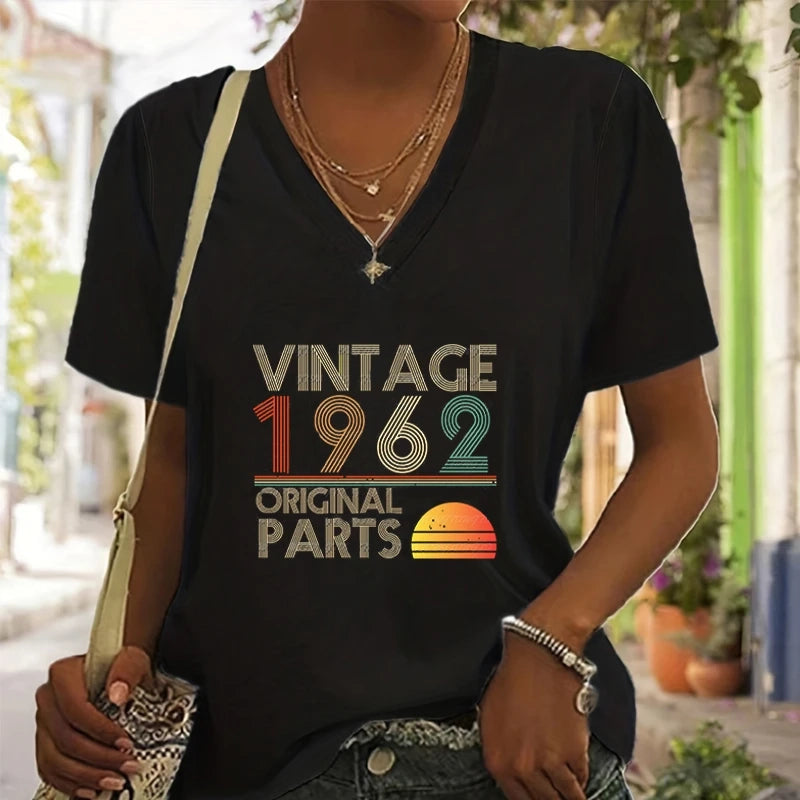 Person wearing a black t-shirt with 'Vintage 1962 Original Parts' design outdoors.
