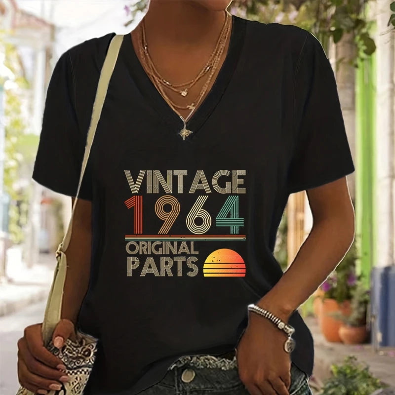 Person wearing a black t-shirt with 'Vintage 1964 Original Parts' design outdoors.