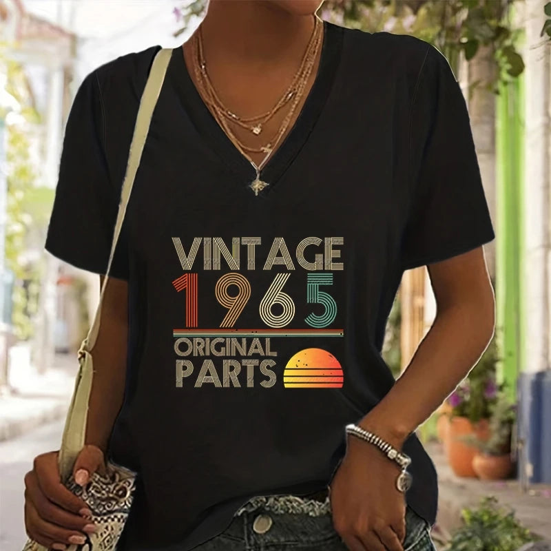 Person wearing a black t-shirt with 'Vintage 1965 Original Parts' design outdoors.