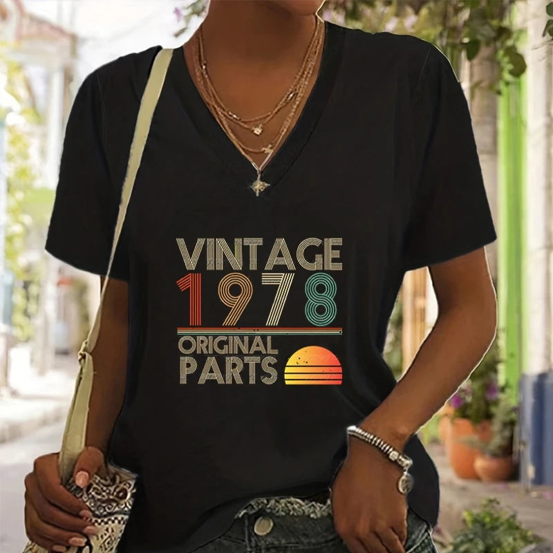 Person wearing a black t-shirt with 'Vintage 1978 Original Parts' design outdoors.