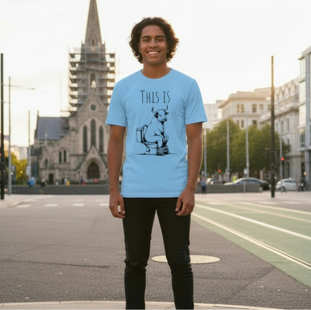 Man wearing a blue shirt with a cartoon Bull on it, in front of Cathedral Square city background