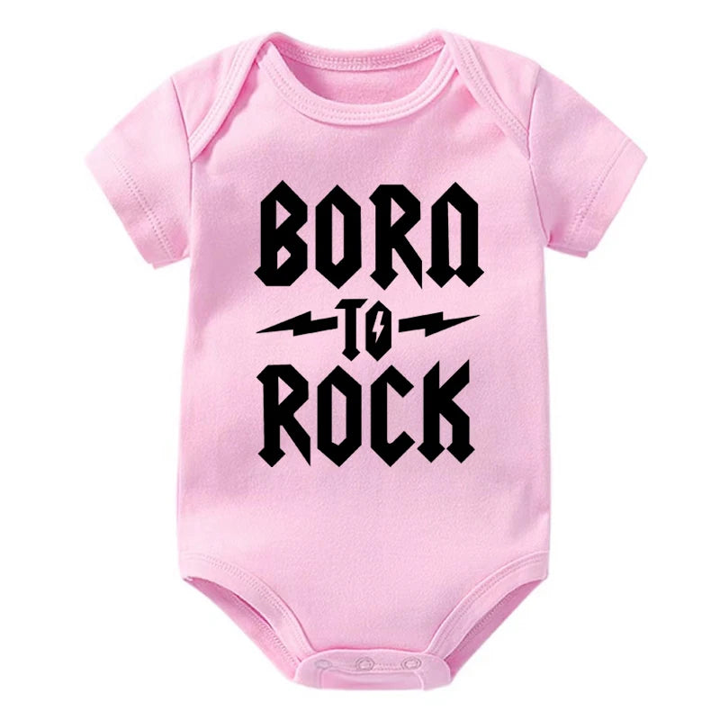Pink baby onesie with 'Born to Rock' text on a white background