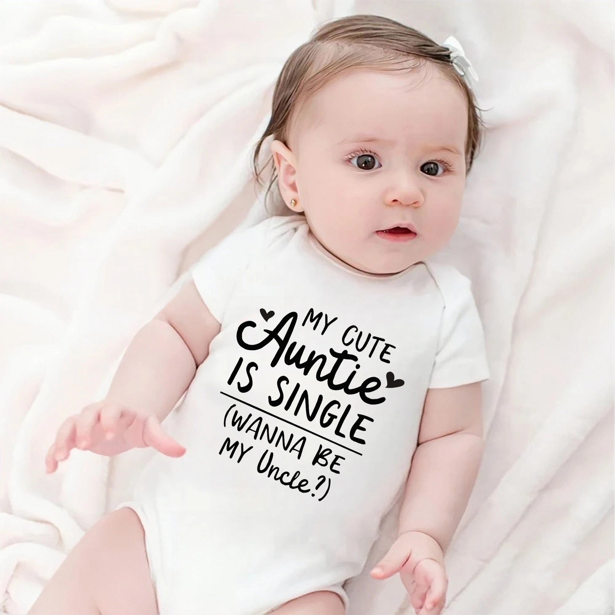 Baby wearing a onesie with text on a white background