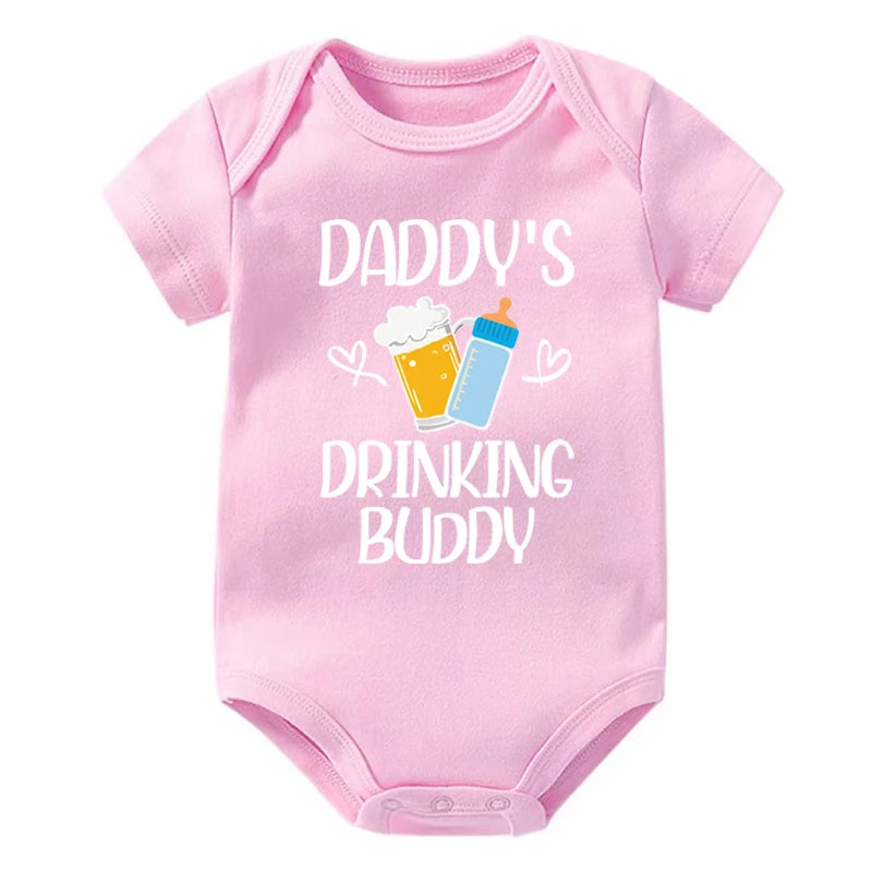 Pink baby onesie with 'Daddy's Drinking Buddy' text and graphics on a white background