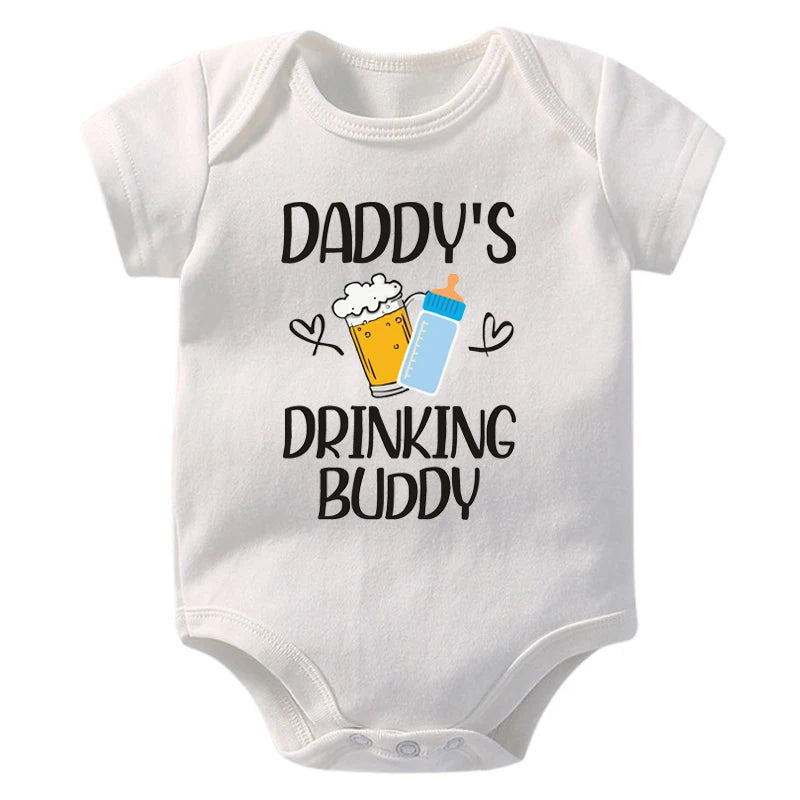 White baby onesie with 'Daddy's Drinking Buddy' text and graphics on a white background