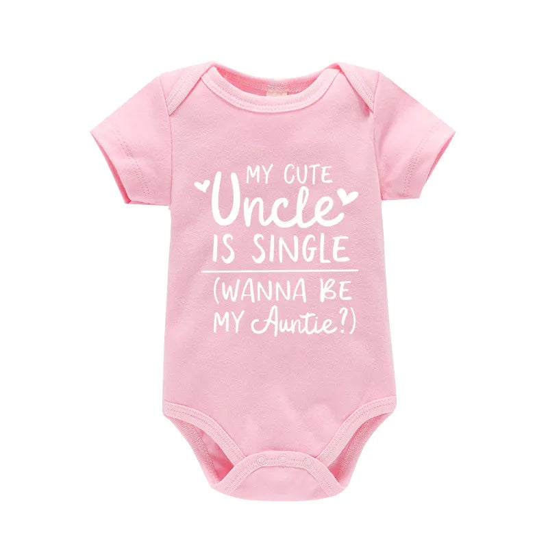 Pink baby onesie with white text on a white background