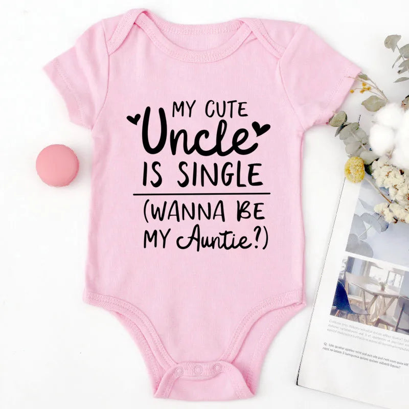 Pink baby onesie with text on a white background