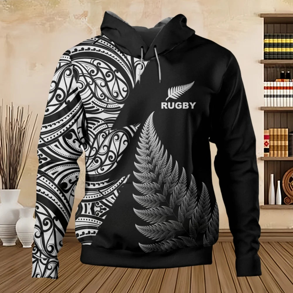 Black hoodie with white fern design and 'Rugby' text, displayed indoors.