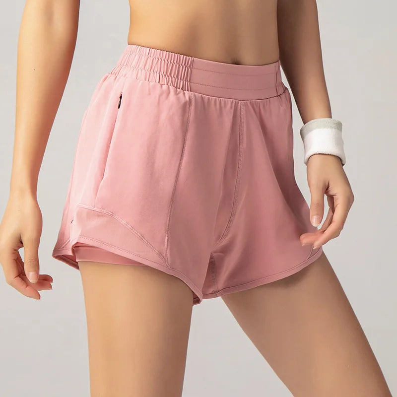 Pink athletic shorts worn by a person on a plain background