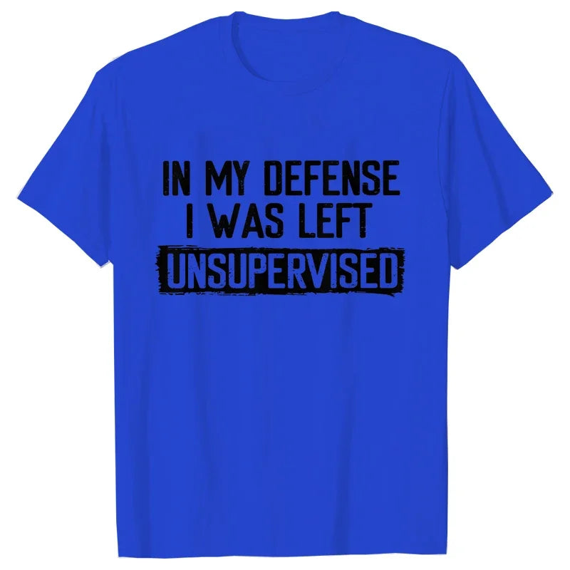 Blue t-shirt with black text 'IN MY DEFENSE I WAS LEFT UNSUPERVISED' on a white background