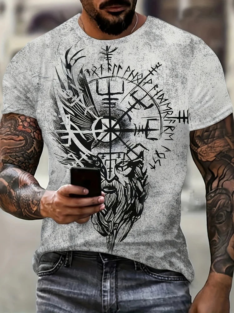 Man wearing a t-shirt with a Viking design, holding a phone.