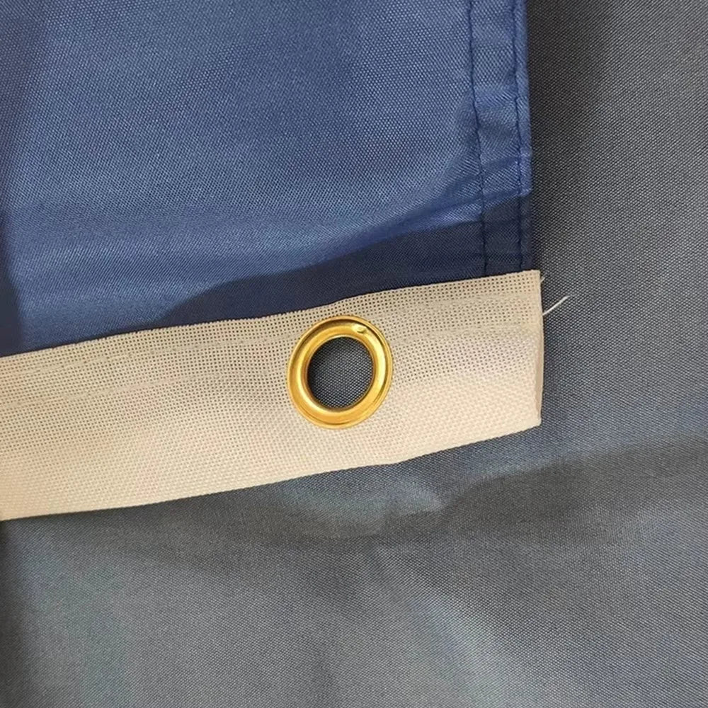 Close-up of a blue and gray fabric with a gold grommet.