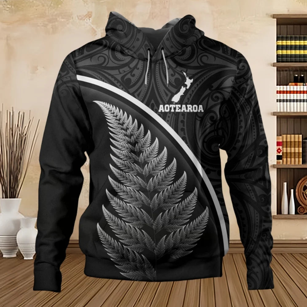 Black hoodie with silver fern design and 'Aotearoa' text in a room setting