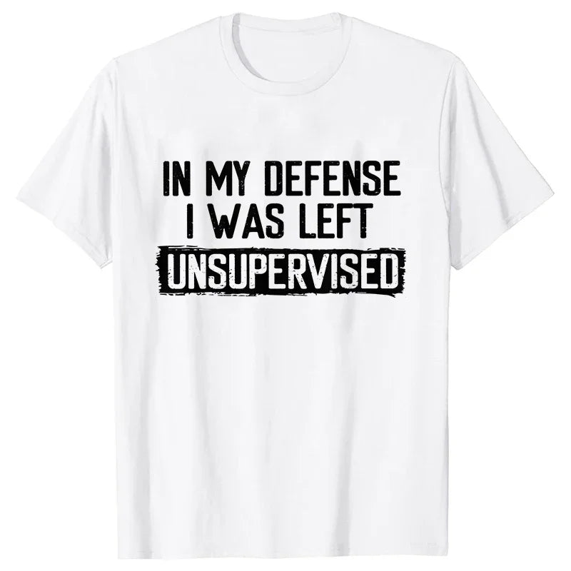 White t-shirt with black text 'IN MY DEFENSE I WAS LEFT UNSUPERVISED' on a white background