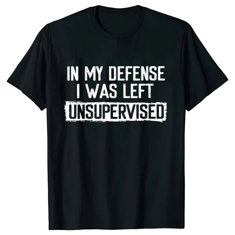 Black t-shirt with white text 'IN MY DEFENSE I WAS LEFT UNSUPERVISED' on a white background