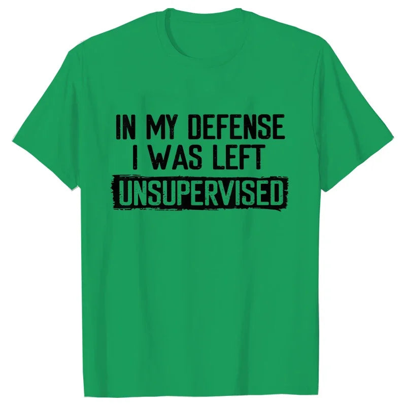 Green t-shirt with black text 'IN MY DEFENSE I WAS LEFT UNSUPERVISED' on a white background