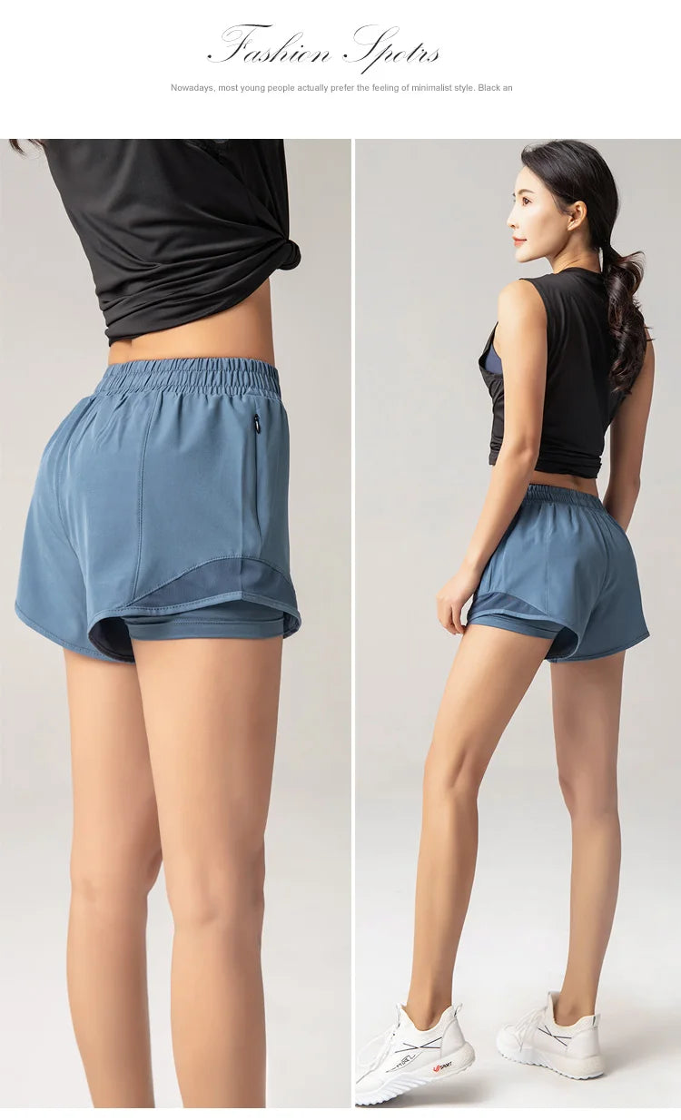 Woman wearing blue athletic shorts with a plain background