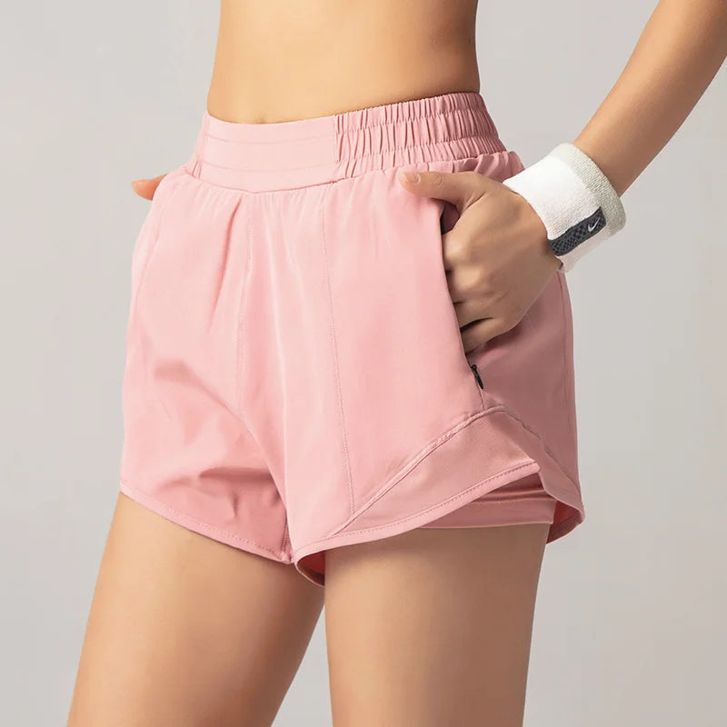 Person wearing pink athletic shorts on a plain background