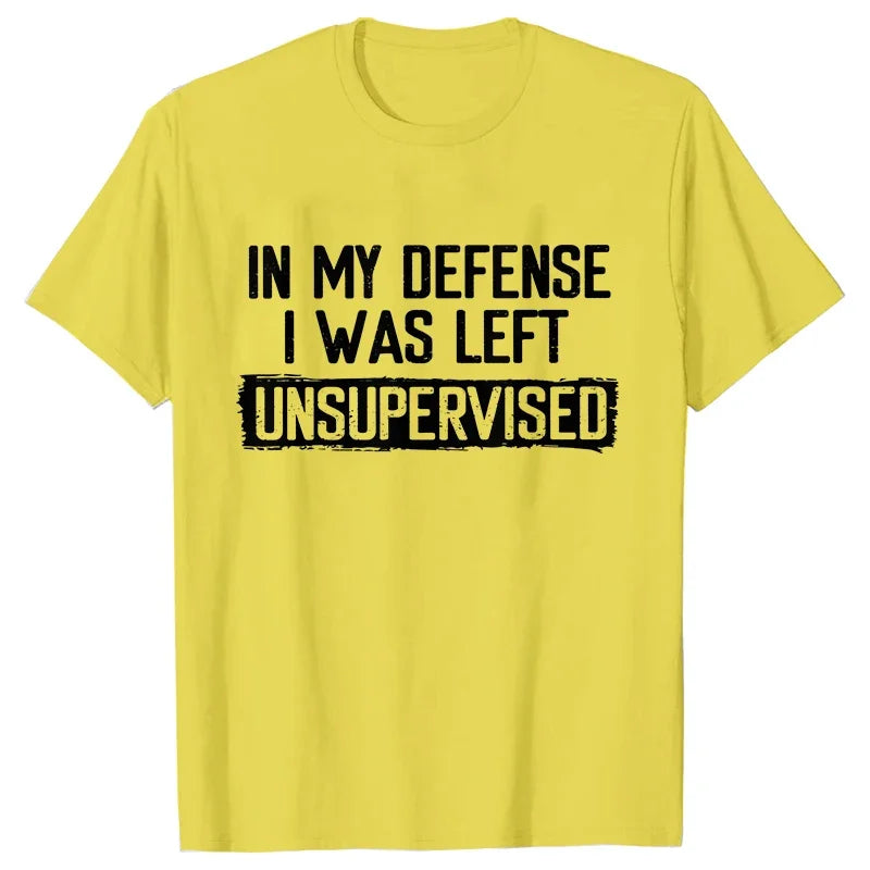 Yellow t-shirt with black text 'IN MY DEFENSE I WAS LEFT UNSUPERVISED' on a white background