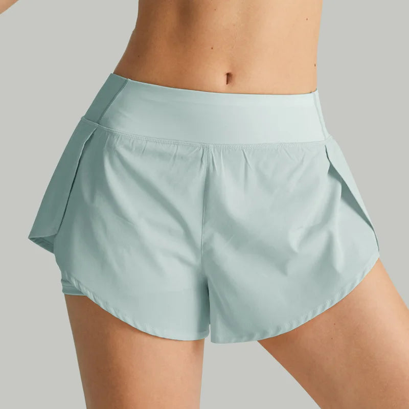 Light blue athletic shorts worn by a person on a gray background