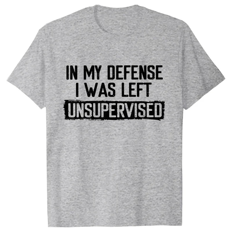Gray t-shirt with black text 'IN MY DEFENSE I WAS LEFT UNSUPERVISED' on a white background