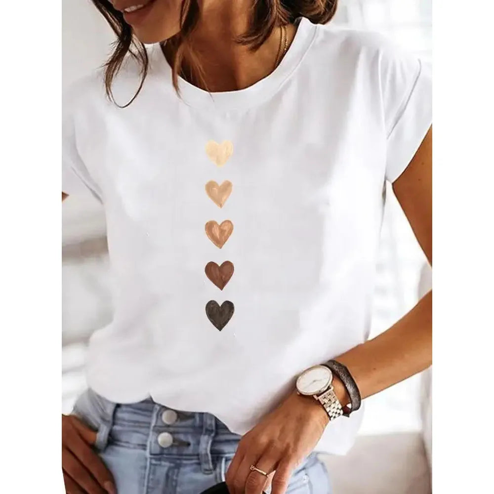 White t-shirt with heart designs worn by a person, with a focus on the shirt.