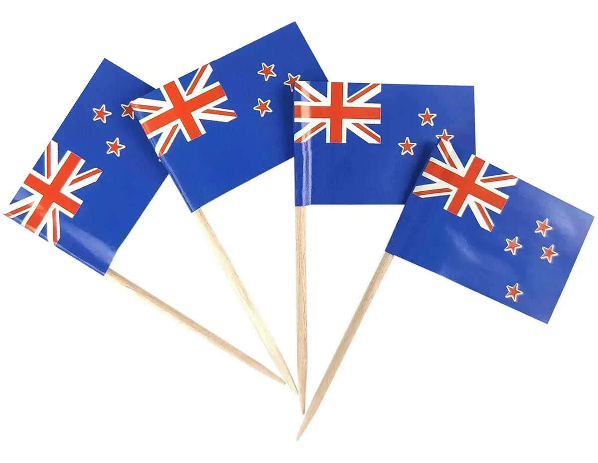 Four New Zealand flags on toothpicks against a white background