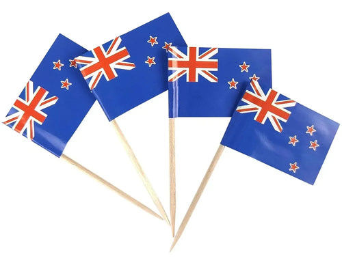 Four New Zealand flags on toothpicks against a white background
