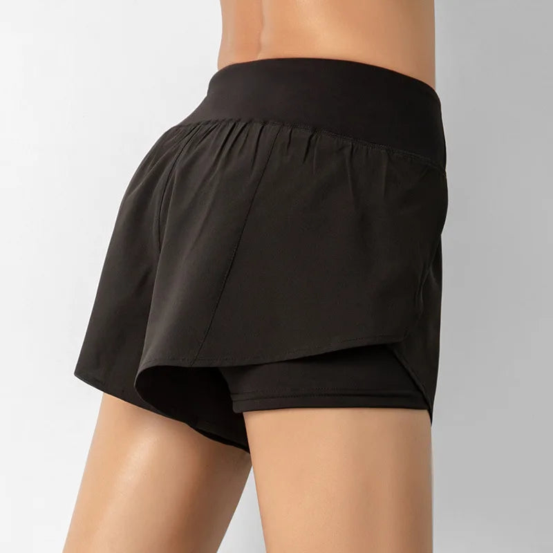 Black shorts worn by a person on a plain background
