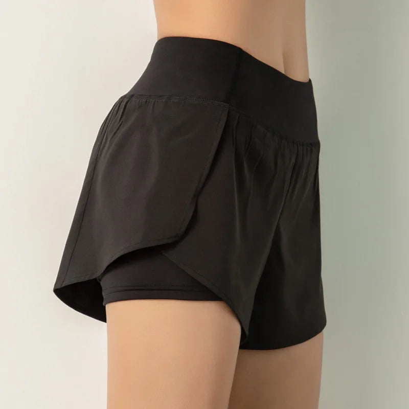 Black shorts worn by a person on a plain background
