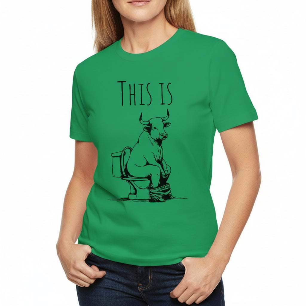 Green t-shirt with a graphic of a bull on a toilet and text 'THIS IS'.