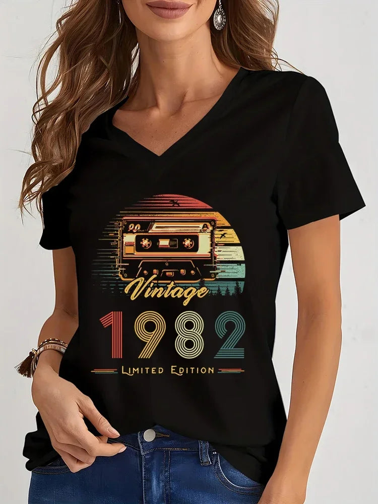 Person wearing a black t-shirt with a vintage 1982 design.