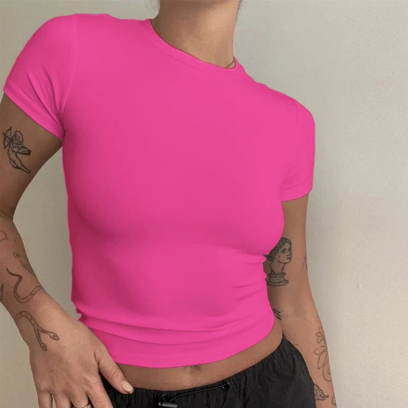 Person wearing a bright pink t-shirt against a neutral background